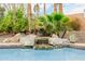 Stunning rock waterfall feature enhances the pool's beauty and tranquility at 8924 E Charter Oak Dr, Scottsdale, AZ 85260