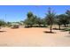 Daytime view of the baseball field with sports lighting and grassy surrounding, perfect for outdoor activities at 9012 E Sutton Dr, Scottsdale, AZ 85260