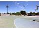 Full outdoor basketball court with multiple hoops, court lines and lighting at 9012 E Sutton Dr, Scottsdale, AZ 85260