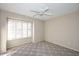 Well-lit bedroom featuring neutral paint, plush carpet, a ceiling fan, and window with plantation shutters at 9012 E Sutton Dr, Scottsdale, AZ 85260