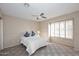 Bright bedroom featuring carpet, ceiling fan, and shuttered windows at 9012 E Sutton Dr, Scottsdale, AZ 85260