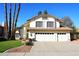 Charming two-story home with a three-car garage, tile roof, desert landscaping, and palm trees at 9012 E Sutton Dr, Scottsdale, AZ 85260