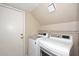 Functional laundry area featuring modern washer and dryer units with overhead lighting at 9012 E Sutton Dr, Scottsdale, AZ 85260