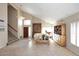 Spacious Living Room showcasing vaulted ceilings, neutral walls, fireplace and tile floors at 9012 E Sutton Dr, Scottsdale, AZ 85260