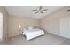 Neutral main bedroom featuring plush carpet, a ceiling fan, a side table with lamp, and white bedroom furniture at 9012 E Sutton Dr, Scottsdale, AZ 85260