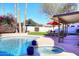 Inviting pool and spa in a backyard oasis with mature landscaping and a covered patio at 9012 E Sutton Dr, Scottsdale, AZ 85260