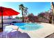 Backyard pool area featuring lush greenery, palm trees and patio furniture at 9012 E Sutton Dr, Scottsdale, AZ 85260