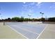 Outdoor tennis courts with nets, lighting and fencing at 9012 E Sutton Dr, Scottsdale, AZ 85260