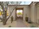 Inviting courtyard entrance with a stone pathway, desert landscaping, and a decorative wrought iron gate at 9280 E Thompson Peak Pkwy # 29, Scottsdale, AZ 85255