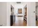 Hallway view into an open concept dining area with a wet bar, and hardwood floors with light neutral paint at 9280 E Thompson Peak Pkwy # 29, Scottsdale, AZ 85255