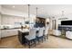 Open concept kitchen with black and white cabinets, a center island with seating, and pendant lighting at 9280 E Thompson Peak Pkwy # 29, Scottsdale, AZ 85255