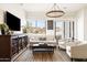 Comfortable living room featuring a dark wood media cabinet, neutral seating, and large windows for natural light at 9280 E Thompson Peak Pkwy # 29, Scottsdale, AZ 85255