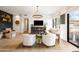 Inviting living room with a decorative chandelier, comfortable seating, and a dark accent wall with shelving at 9280 E Thompson Peak Pkwy # 29, Scottsdale, AZ 85255