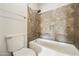 Bathroom featuring a white toilet, tiled walls, and a tiled bathtub and shower combination at 9450 E Becker Ln # 2090, Scottsdale, AZ 85260