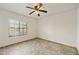 Bedroom with neutral walls, tile flooring, a ceiling fan, and a window with neighborhood views at 9450 E Becker Ln # 2090, Scottsdale, AZ 85260