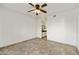 Spacious bedroom featuring neutral walls, tile flooring, and a ceiling fan with a view into the bathroom at 9450 E Becker Ln # 2090, Scottsdale, AZ 85260