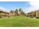 A sprawling green common area is surrounded by residential buildings, fostering a sense of community at 9450 E Becker Ln # 2090, Scottsdale, AZ 85260