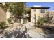 Beautiful condo building featuring a walkway, natural landscaping, and classic desert architecture at 9450 E Becker Ln # 2090, Scottsdale, AZ 85260