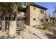 Inviting condo building with an exterior staircase, lush landscaping, and a well-maintained facade at 9450 E Becker Ln # 2090, Scottsdale, AZ 85260