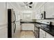 Efficient kitchen featuring stainless steel appliances, white cabinetry, and dark countertops at 9450 E Becker Ln # 2090, Scottsdale, AZ 85260