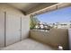 Outdoor patio with concrete flooring, a door, and views of a complex with mature trees at 9450 E Becker Ln # 2090, Scottsdale, AZ 85260