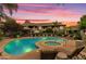 A serene pool and spa area, illuminated by vibrant twilight hues, offer a tranquil escape at 9450 E Becker Ln # 2090, Scottsdale, AZ 85260