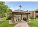 A poolside pavilion offers a covered gathering area with seating, a grill, and views of the lush grounds at 9450 E Becker Ln # 2090, Scottsdale, AZ 85260