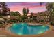 Relaxing community pool with lounge chairs and spa, beautifully lit at sunset at 9450 E Becker Ln # 2090, Scottsdale, AZ 85260