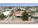 This aerial shot displays a charming home with a tile roof and a cozy, screened-in patio overlooking a lush green golf course at 9576 E Fairway Blvd, Sun Lakes, AZ 85248