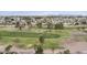 Expansive aerial view of a golf course community featuring lush green fairways and mature trees with a mountain backdrop at 9576 E Fairway Blvd, Sun Lakes, AZ 85248