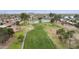 Scenic aerial view of the community golf course with lush green fairways and a tranquil pond at 9576 E Fairway Blvd, Sun Lakes, AZ 85248