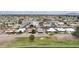 Aerial view of a desert community, showcasing single-Gathering homes with well-maintained landscapes and nearby golf course at 9576 E Fairway Blvd, Sun Lakes, AZ 85248