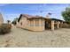 View of the home's backyard with a covered patio, rock landscaping, and plenty of space for outdoor activities at 9576 E Fairway Blvd, Sun Lakes, AZ 85248