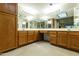 Bright bathroom featuring double sinks, a vanity, and ample mirror space at 9576 E Fairway Blvd, Sun Lakes, AZ 85248