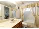 Well-lit bathroom features a vanity, toilet, bathtub, and neutral color palette at 9576 E Fairway Blvd, Sun Lakes, AZ 85248