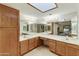 Bright bathroom featuring double sinks, a vanity, and ample mirror space at 9576 E Fairway Blvd, Sun Lakes, AZ 85248