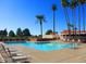 A refreshing community pool with lounge chairs and palm trees, offering a relaxing outdoor space for residents at 9576 E Fairway Blvd, Sun Lakes, AZ 85248