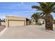 Inviting single-story home with a desert landscape and tall palm trees enhancing the curb appeal at 9576 E Fairway Blvd, Sun Lakes, AZ 85248