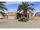 Inviting single-story home with a desert landscape and tall palm trees enhancing the curb appeal at 9576 E Fairway Blvd, Sun Lakes, AZ 85248