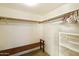 Empty walk-in closet with built-in shelving and a bench at 9576 E Fairway Blvd, Sun Lakes, AZ 85248