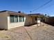 Gravel backyard features a covered patio with brick area at 1001 W 17Th St, Tempe, AZ 85281