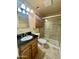 Bathroom with a vanity featuring a black countertop, wood cabinets, a toilet and a shower with glass doors at 1001 W 17Th St, Tempe, AZ 85281