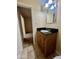 A close-up of the vanity that has black granite countertops and wooden cabinets at 1001 W 17Th St, Tempe, AZ 85281