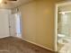 View of a bedroom featuring neutral walls, carpet, and doorway access to a bathroom and additional room at 1001 W 17Th St, Tempe, AZ 85281