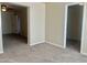 Bedroom featuring light neutral walls and tan carpet, and hallway entry to additional living space at 1001 W 17Th St, Tempe, AZ 85281