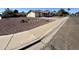 Street view of a tidy home featuring a driveway with low-maintenance landscaping and mature trees at 1001 W 17Th St, Tempe, AZ 85281