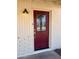 Close up view of the front door, painted red and featuring glass detailing at 1001 W 17Th St, Tempe, AZ 85281