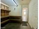 Garage with exterior door, shelving, and workbench at 1001 W 17Th St, Tempe, AZ 85281