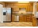 This kitchen is equipped with stainless steel appliances, granite countertops, and wood cabinets at 1001 W 17Th St, Tempe, AZ 85281