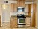 Well-lit kitchen with stainless steel range, microwave, and beautiful wood cabinets at 1001 W 17Th St, Tempe, AZ 85281